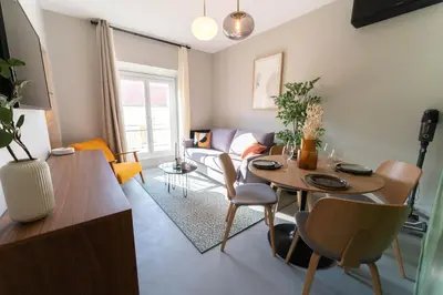 a living room with a table and a couch at Old Town Diamond, adorable sunny apartment with AC in Nice