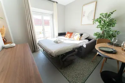 a small room with a bed and a table at Old Town Diamond, adorable sunny apartment with AC in Nice