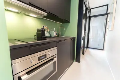 a kitchen with green walls and a counter top at Old Town Diamond, adorable sunny apartment with AC in Nice