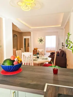 a bowl of fruit sitting on a table in a kitchen at Charmant appartement - Climatisation - Nice in Nice