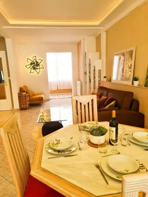 a dining room table with plates and wine glasses at Charmant appartement - Climatisation - Nice in Nice