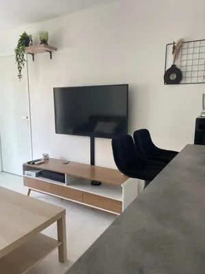 a living room with a flat screen tv on a wall at Le soleil Niçois, proche du port in Nice