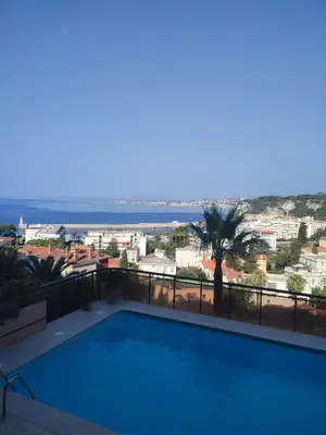 a swimming pool with a view of the ocean at L'évidence in Nice
