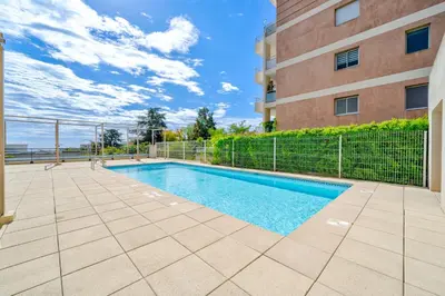 a swimming pool in front of a building at Magnifique 4 pers,Clim,parking in Nice
