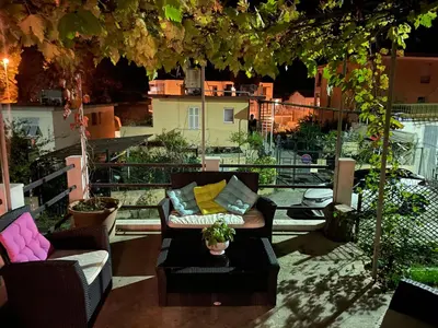a patio with two chairs and a couch and a table at Studio climatisé avec terrasse ombragée dans maison au calme et dans la verdure in Nice