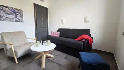 a living room with a couch and a chair at 