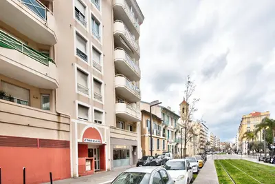 a row of buildings on a street with parked cars at 2P balcon Vue Mer YourHostHelper 2 mins de la mer in Nice
