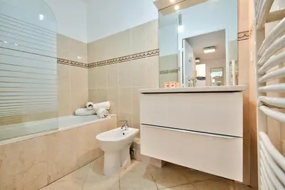 a bathroom with a toilet and a tub and a sink at 2P balcon Vue Mer YourHostHelper 2 mins de la mer in Nice
