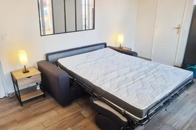 a large bed in a room with two lamps on tables at 