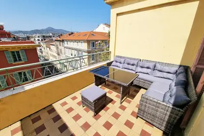 a balcony with a couch and a table on a balcony at 