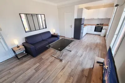 a living room with a blue couch and a table at 