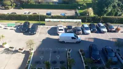 an aerial view of a parking lot with cars at Heliotel Marine Studio avec balcon au 4eme étage à 200m de la mer in Saint-Laurent-du-Var