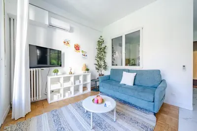 a living room with a blue couch and a table at Charmant 2P au cœur de Nice in Nice