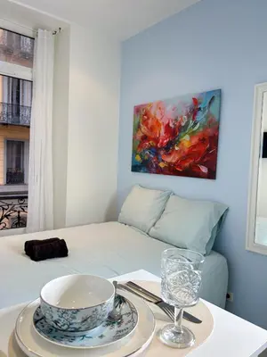 a room with a bed with a bowl on a table at blue sun in Nice