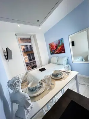 a room with a bed and a table with plates on it at blue sun in Nice