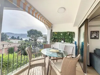 a balcony with a glass table and chairs at Riviera-King-Studio in Villefranche-sur-Mer