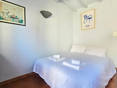 a bedroom with a white bed with two towels on it at 