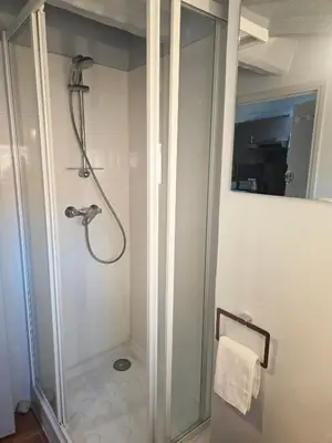 a shower in a bathroom with a glass shower stall at 