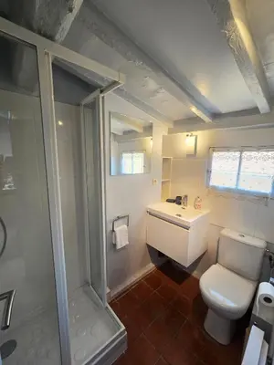 a bathroom with a toilet and a sink and a shower at 