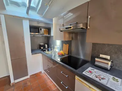 a kitchen with stainless steel cabinets and a black counter top at 