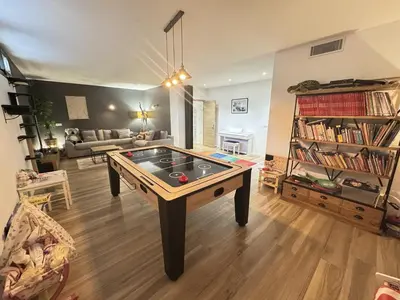 a living room with a ping pong table in it at Villa moderne pour 8 personnes - Vue sur Nice ! in Nice