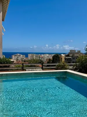 a large swimming pool with a view of the ocean at Villa moderne pour 8 personnes - Vue sur Nice ! in Nice