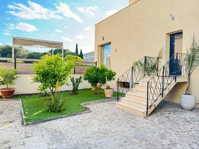 a house with a staircase in a courtyard at Villa moderne pour 8 personnes - Vue sur Nice ! in Nice