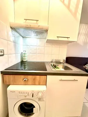 a kitchen with a sink and a washing machine at Studio 600 m de la Promenade des Anglais in Nice