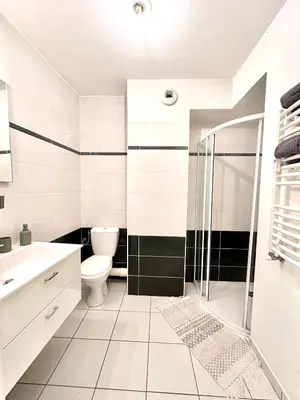 a white bathroom with a shower and a toilet at Studio 600 m de la Promenade des Anglais in Nice