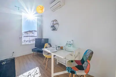 a dining room with a white table and chairs at Cosy 3P en plein cœur de Nice in Nice