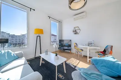 a living room with a couch and a table at Cosy 3P en plein cœur de Nice in Nice