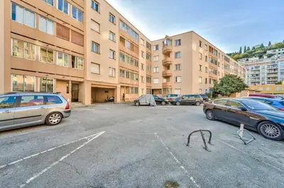 a parking lot with cars parked in front of a building at Modern 2BR Flat - Haut de Nice in Nice