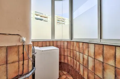 a bathroom with a refrigerator in a room with windows at Modern 2BR Flat - Haut de Nice in Nice