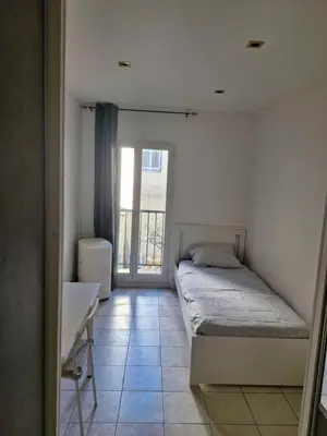 a hallway with an open door in a house at Appartement 4 pièces - gare Nice riquier in Nice