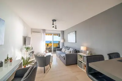a living room with a couch and a table at Sea View & Promenade des Anglais Studio in Nice
