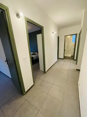 a hallway with doors and a tiled floor at Appartement Californie Beach in Nice