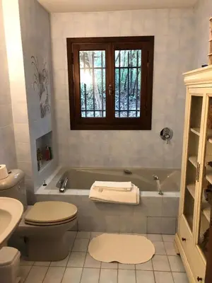 a bathroom with a tub and a toilet and a sink at Villa loucisa Nice piscine vue mer 8 chambres 24 couchages in Nice