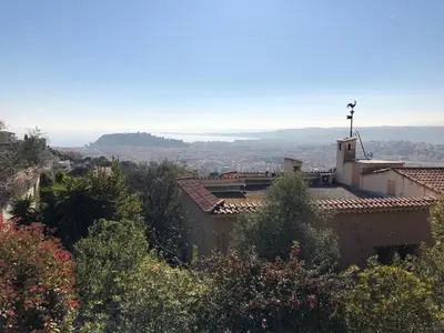 a building on top of a hill with trees at Villa loucisa Nice piscine vue mer 8 chambres 24 couchages in Nice