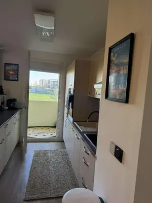 a kitchen with a door open to a kitchen with a window at Olympie, airport, train and tram station Fully equipped for 3 peoples in Nice