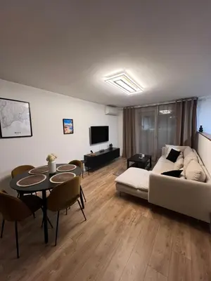 a living room with a couch and a table at Olympie, airport, train and tram station Fully equipped for 3 peoples in Nice