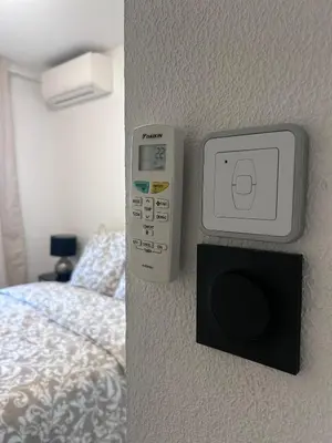 a bedroom with a remote control next to a bed at Olympie, airport, train and tram station Fully equipped for 3 peoples in Nice