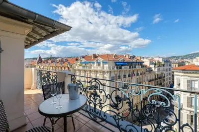 a balcony with a table and a view of a city at Perchoir au coeur de Nice in Nice