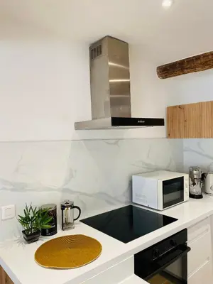 a kitchen with a counter top with a microwave at APPARTEMENT en DUPLEX VIEUX NICE in Nice