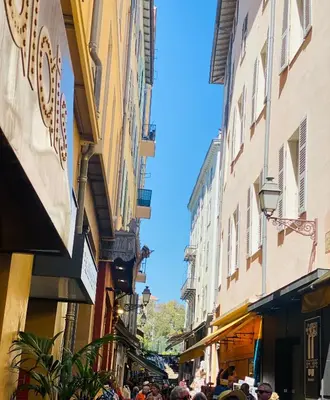 a group of people walking down a street with buildings at APPARTEMENT en DUPLEX VIEUX NICE in Nice
