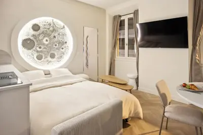 a bedroom with a bed and a desk and a tv at Cosy moon for 4 or 6 people quartier du Port in Nice