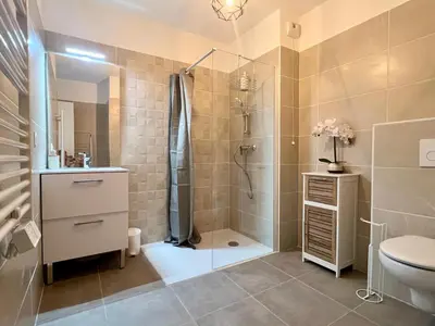 a bathroom with a shower and a toilet and a sink at Brand new flat with terrace and parc view in Nice