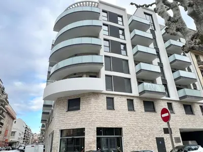 an apartment building with a round window at Brand new flat with terrace and parc view in Nice