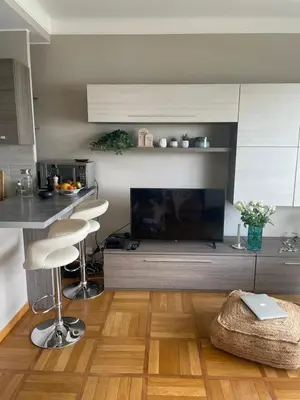 a living room with a fireplace and a table and chairs at Nice Promenade des Anglais Your Seafront Flat in Nice
