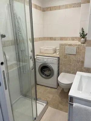 a bathroom with a washing machine and a washer at Nice Promenade des Anglais Your Seafront Flat in Nice