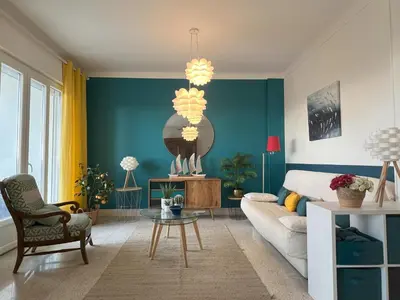 a living room with a couch and a table at Terrace and view on all Nice city in Nice